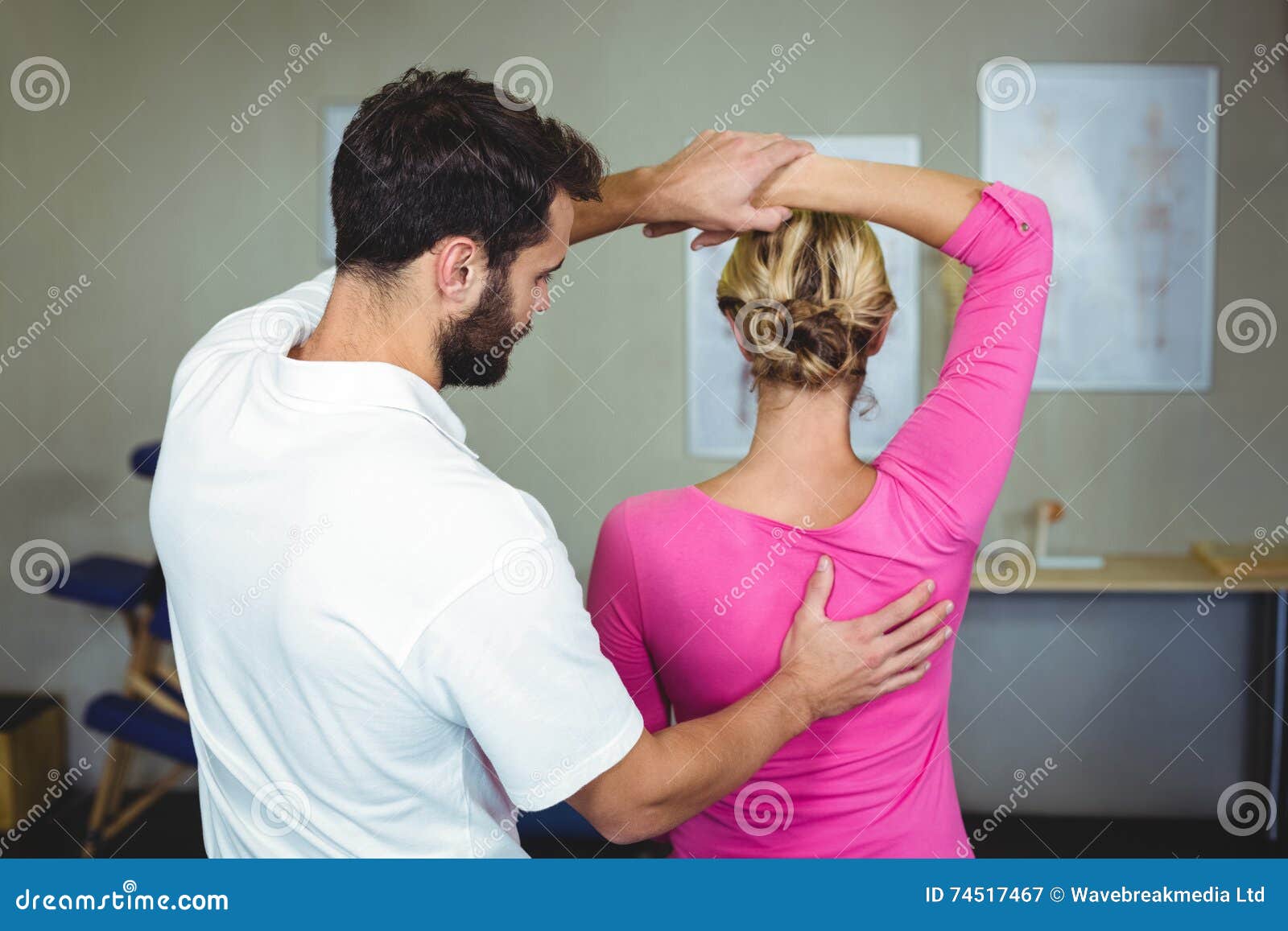 Male Physiotherapist Giving Arm Massage To Female Patient Stock Image