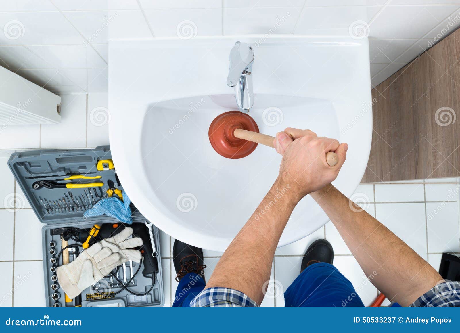 Woman Cleaning Bathroom Sink Drain Using Plunger. Stock Photo, Picture and  Royalty Free Image. Image 176038405.
