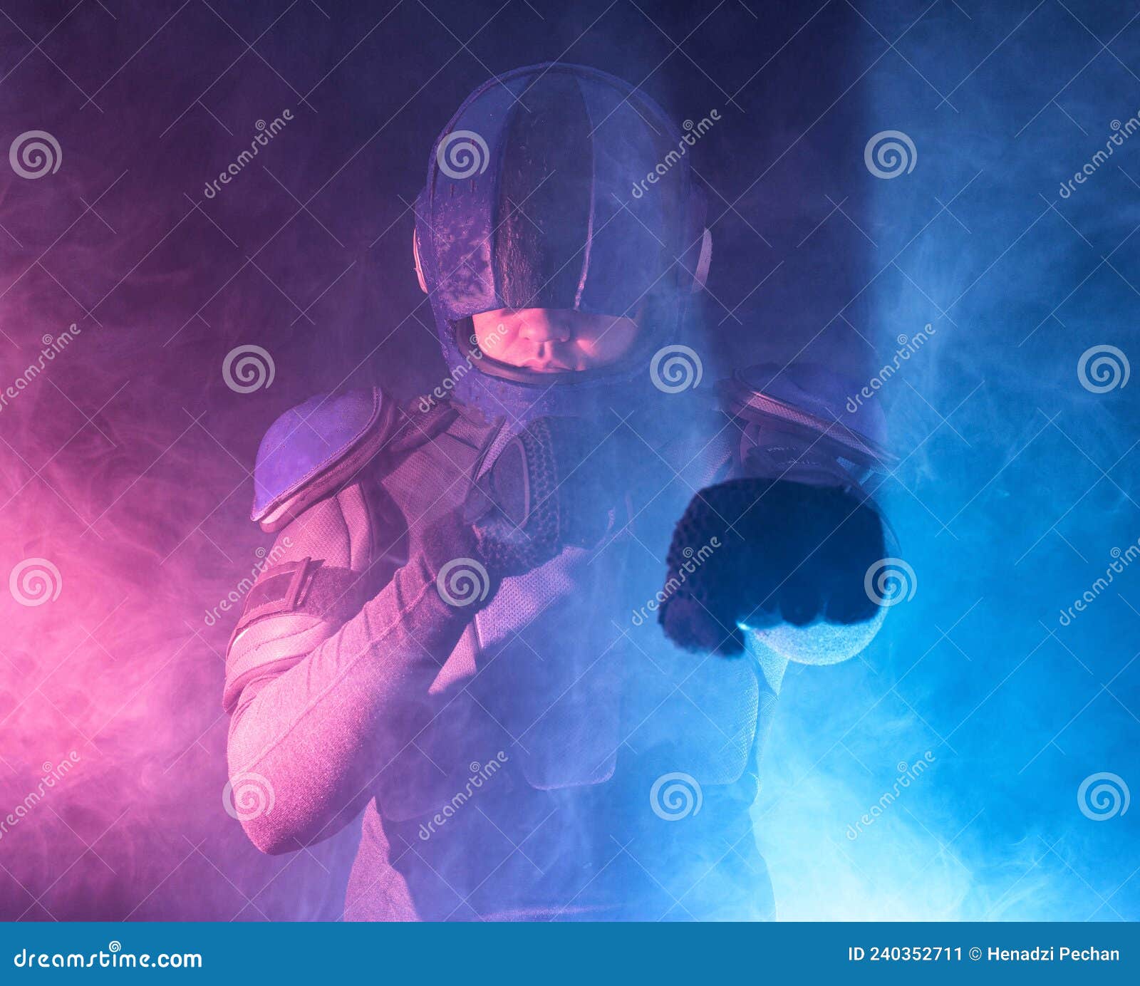 male robot cop waves and punches his fits in dark. halfman is ready for fight. bionic cyborg looks at camera. red blue light. law