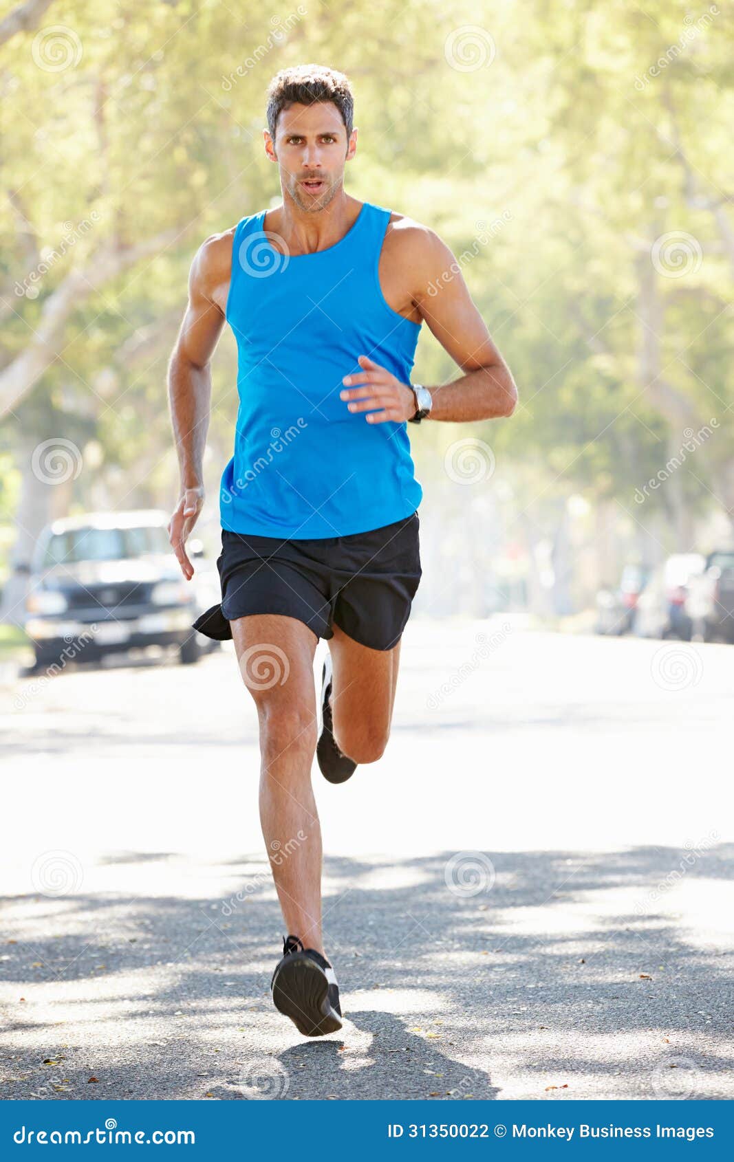 Male Runner Exercising On Suburban Street Stock Photo - Image: 31350022