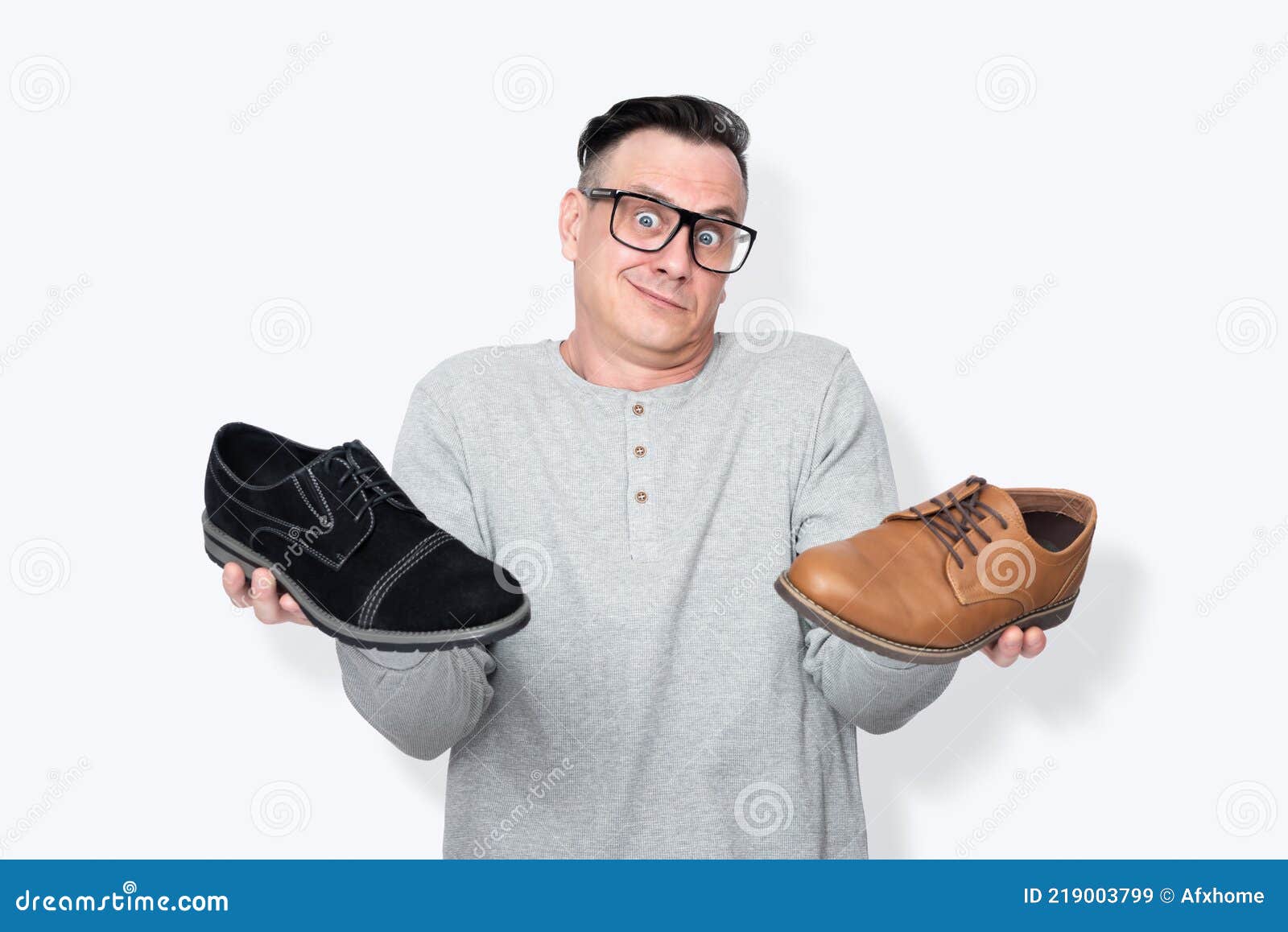 Male Salesman with Glasses Shrugs, Showing Two Different Shoes in His ...