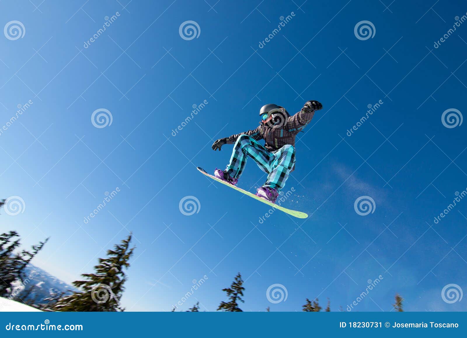male snowboarder catches big air.