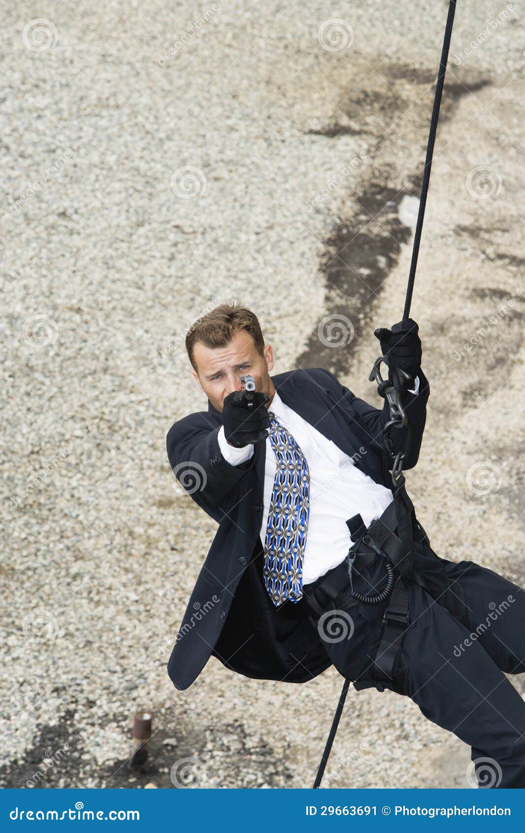 Male Spy Aiming Handgun while Rappelling Stock Image - Image of