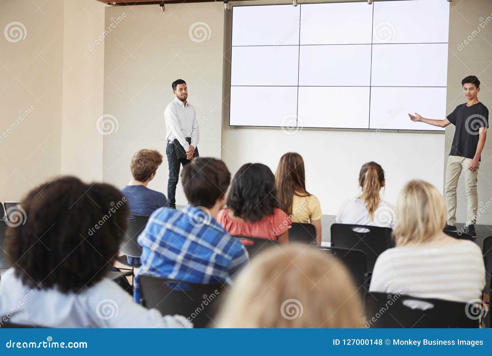 Male Student Giving Presentation To High School Class In Front Of