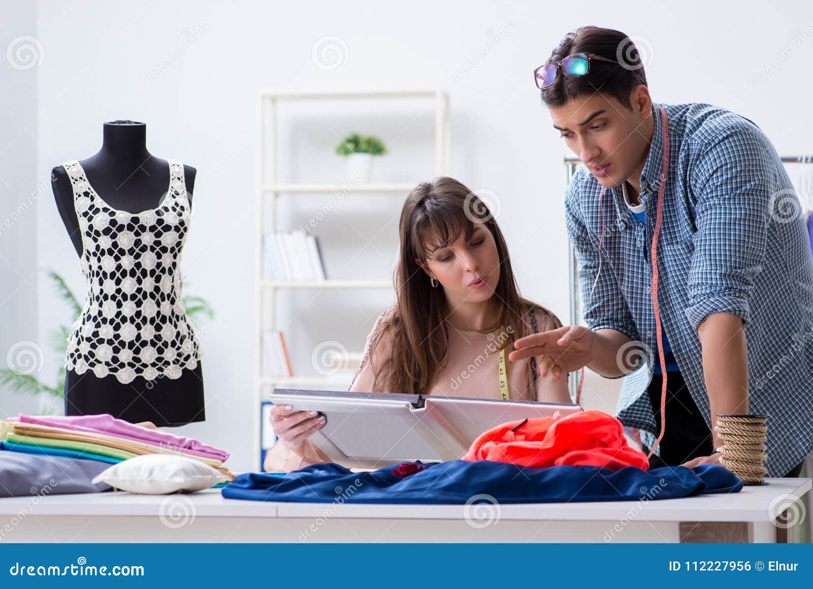 The Male Tailor with Female Student in Workshop Stock Photo - Image of ...