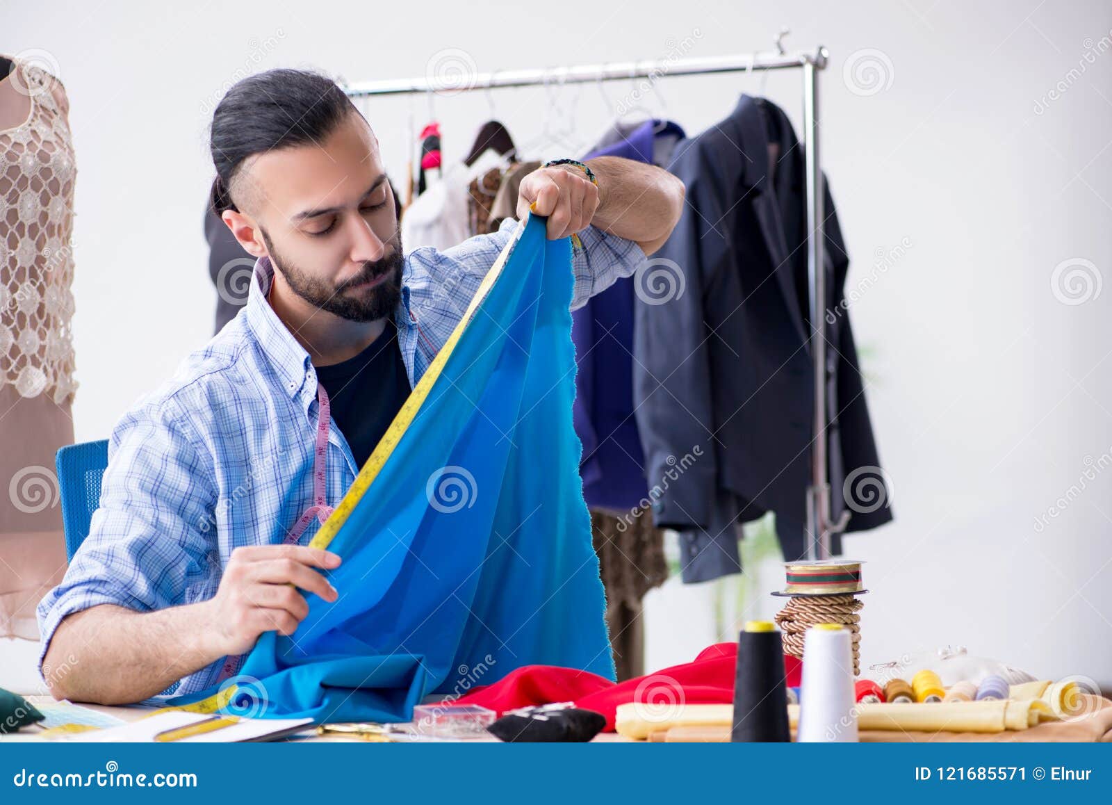 The Male Tailor Working in the on New Designs Stock Image