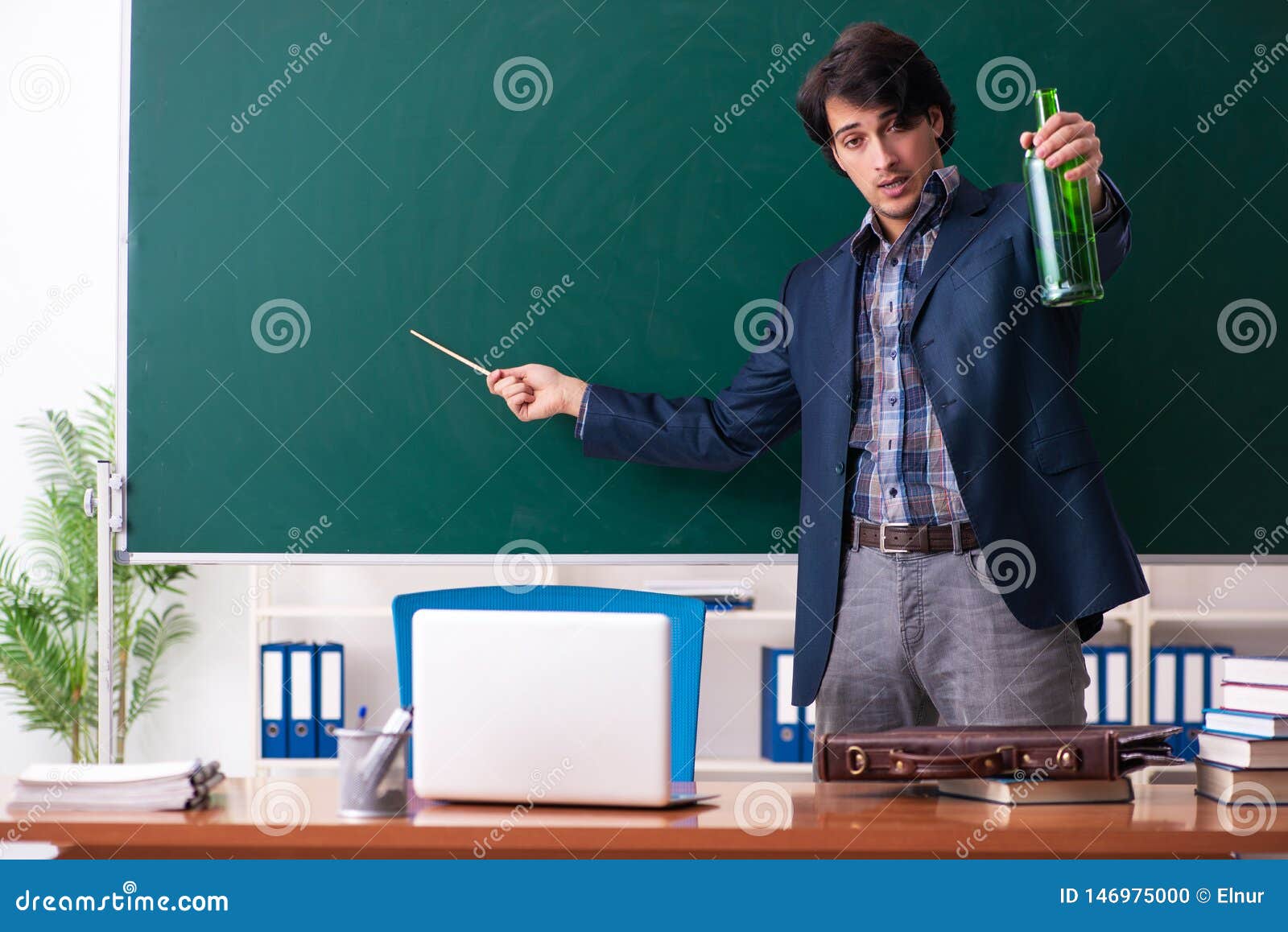 The Male Teacher Drinking in the Classroom Stock Photo Image of