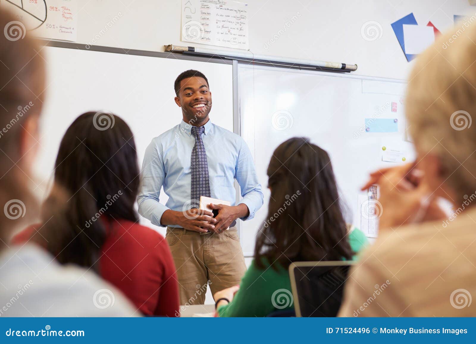 male teacher in front of students at an adult education class