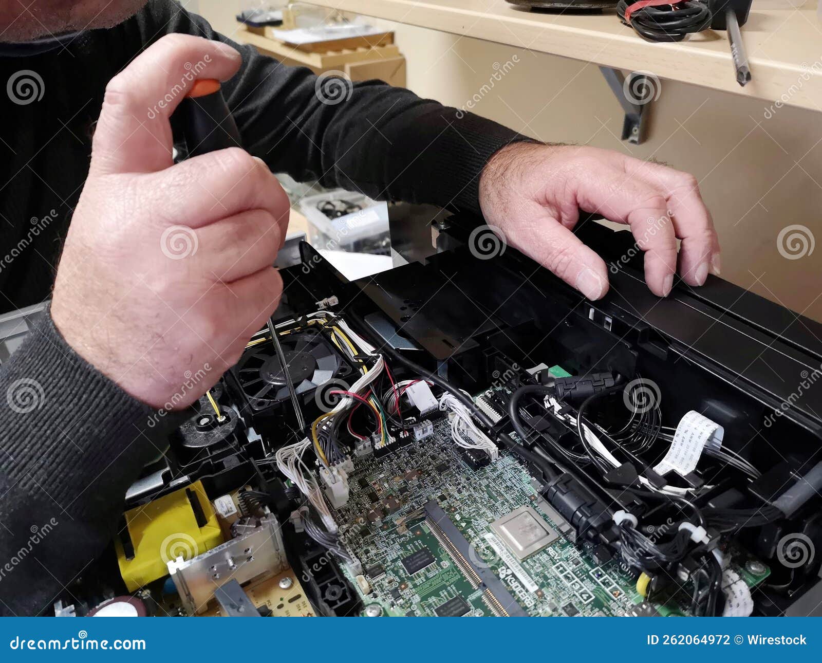 Male Technician at Work Repairing a Black Printer Stock Photo Image