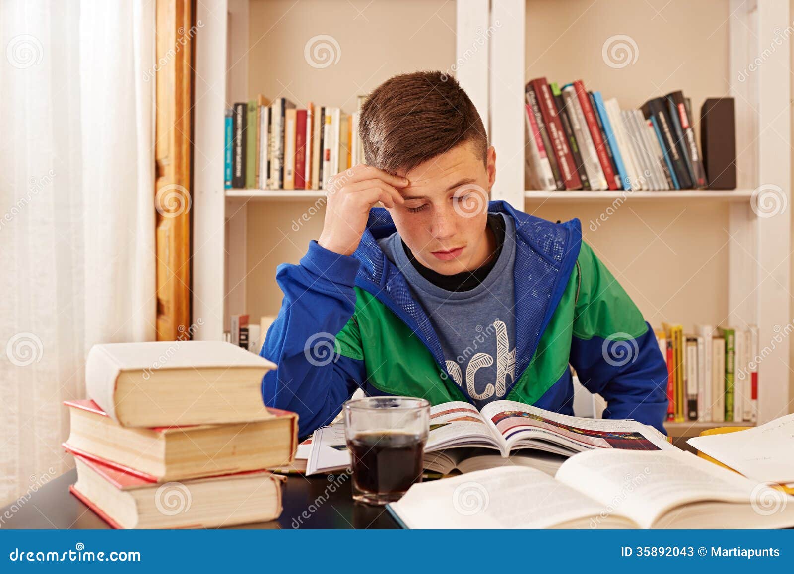 male teenager drinking coke studying desk 35892043