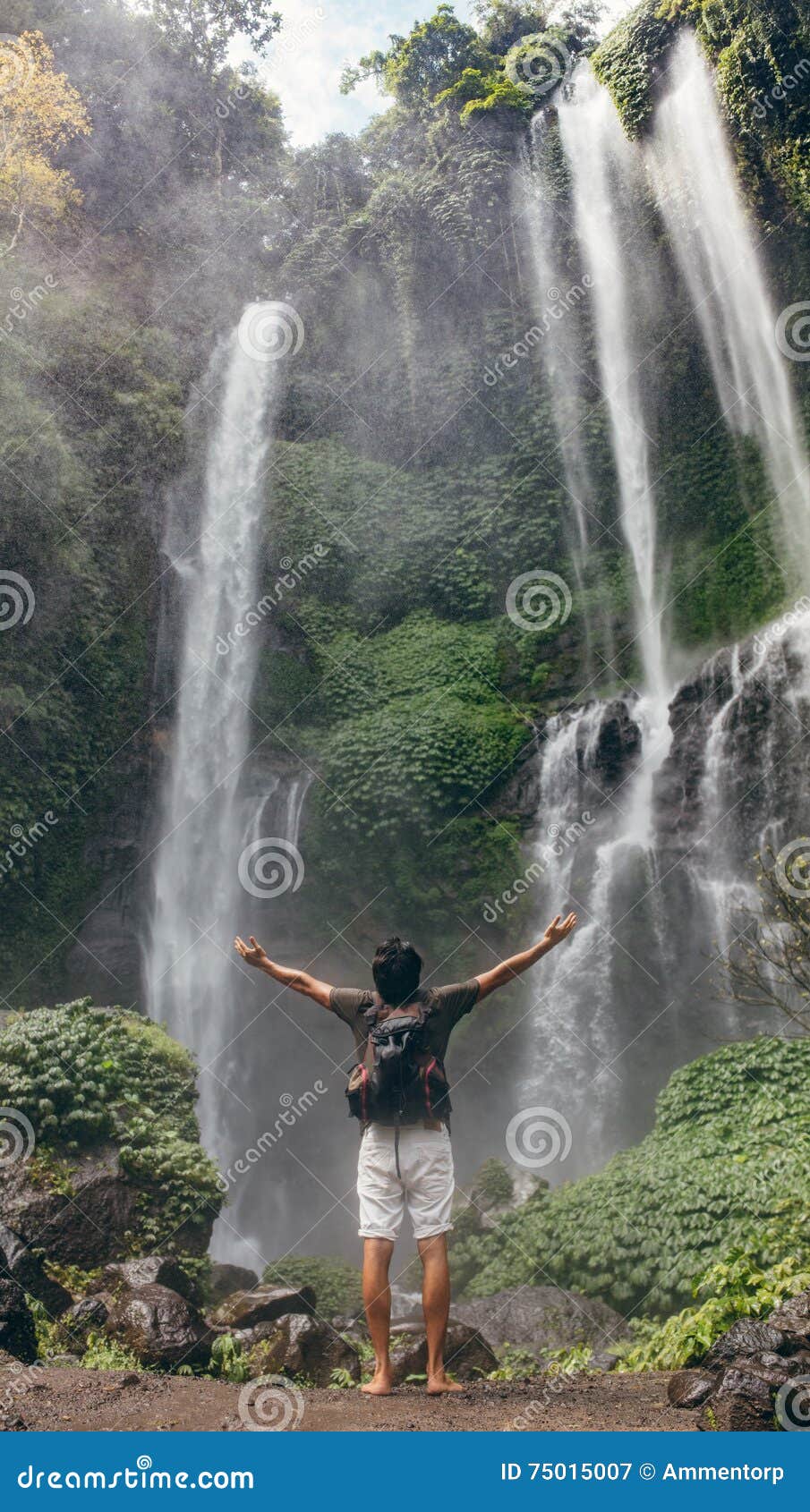 A boy sitting under a waterfall - PixaHive