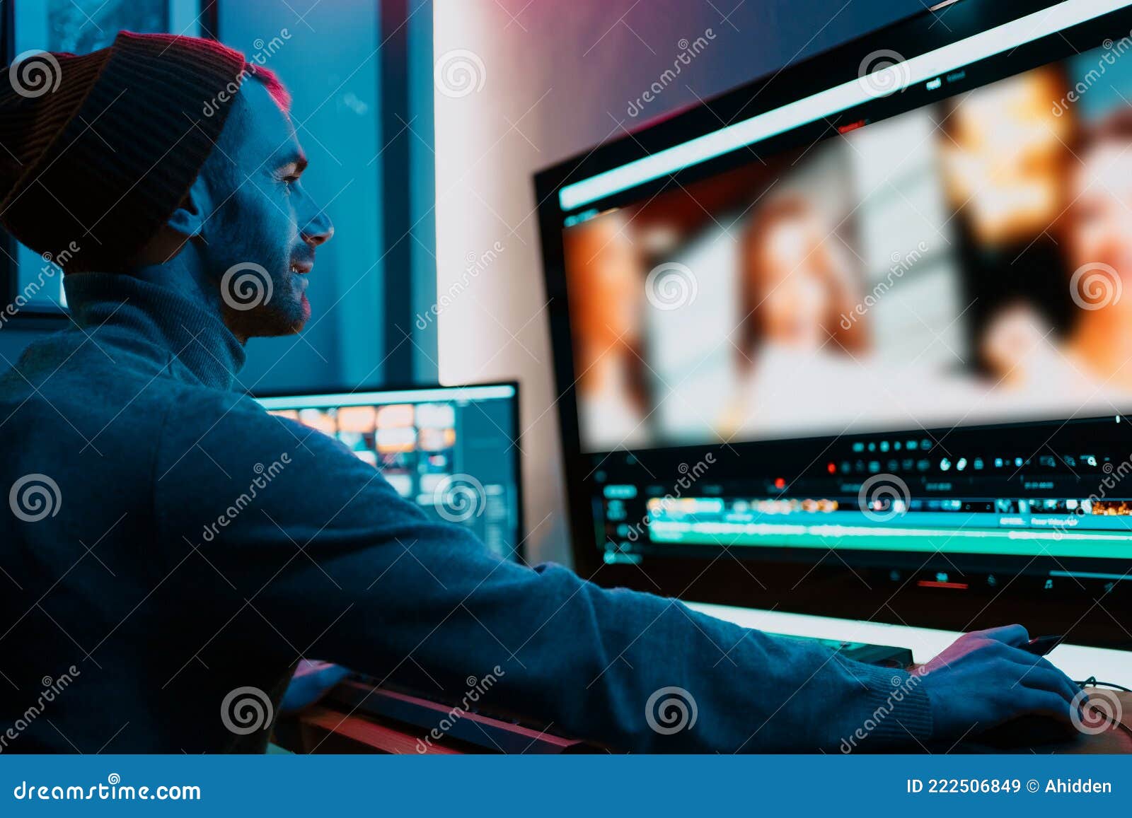 male video editor working on his personal computer with big display