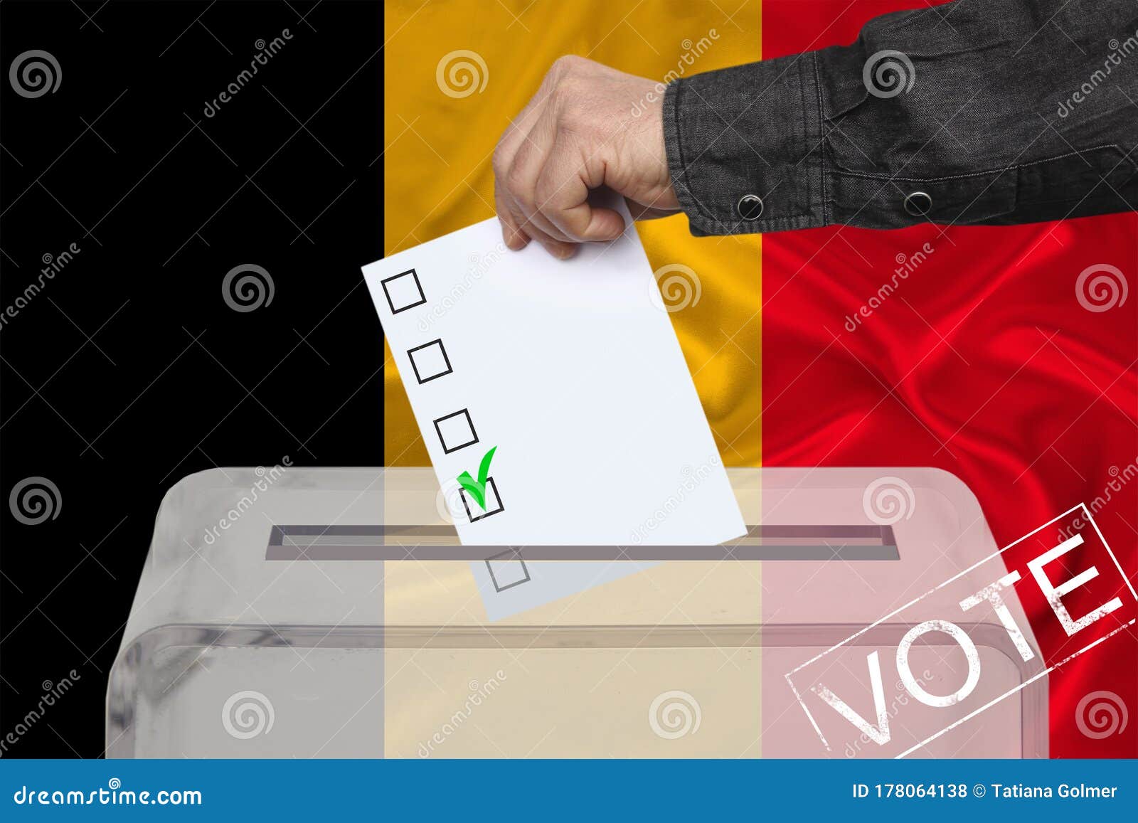 Male Voter Drops A Ballot In A Transparent Ballot Box Against The ...