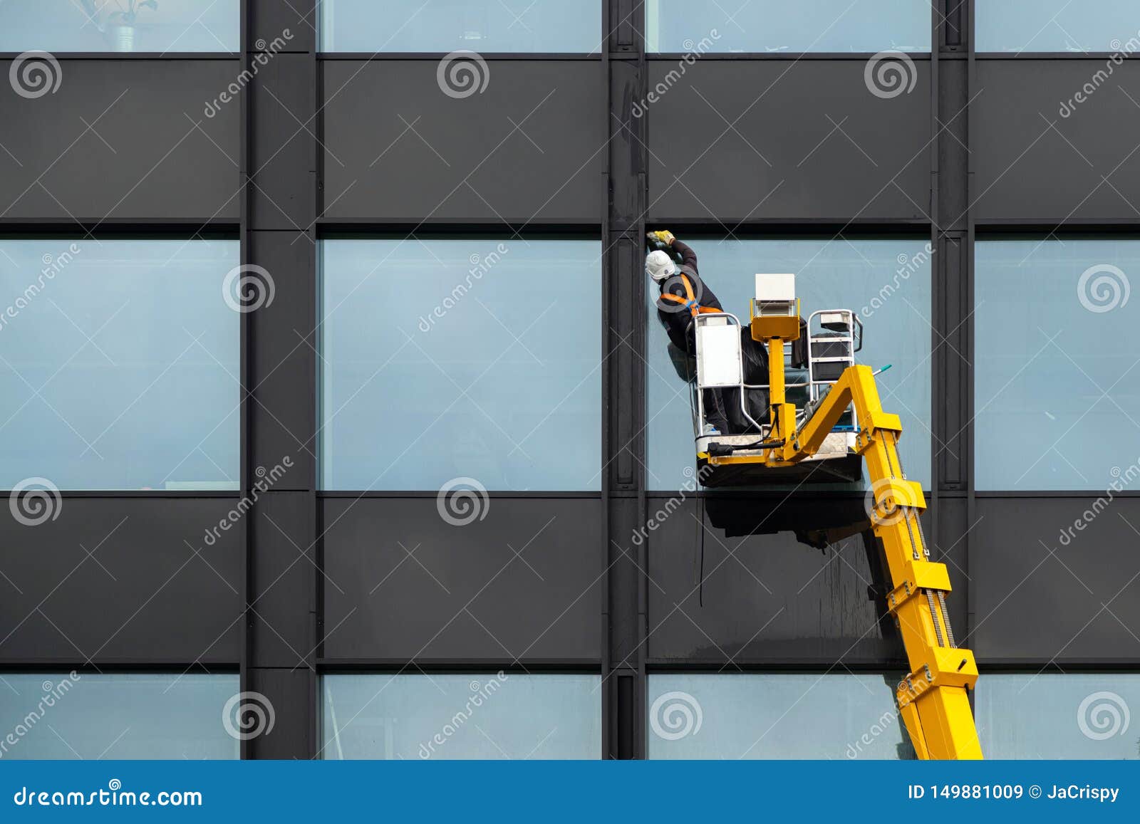 window cleaner has his helmet polished