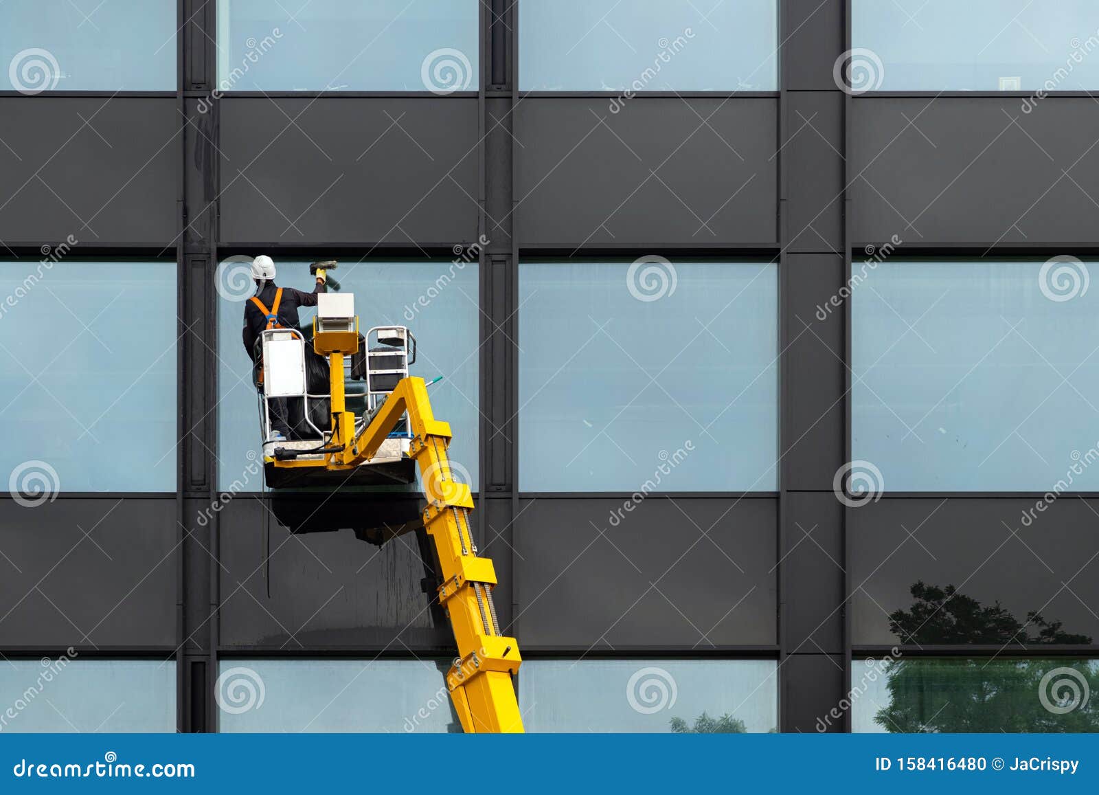 window cleaner has his helmet polished