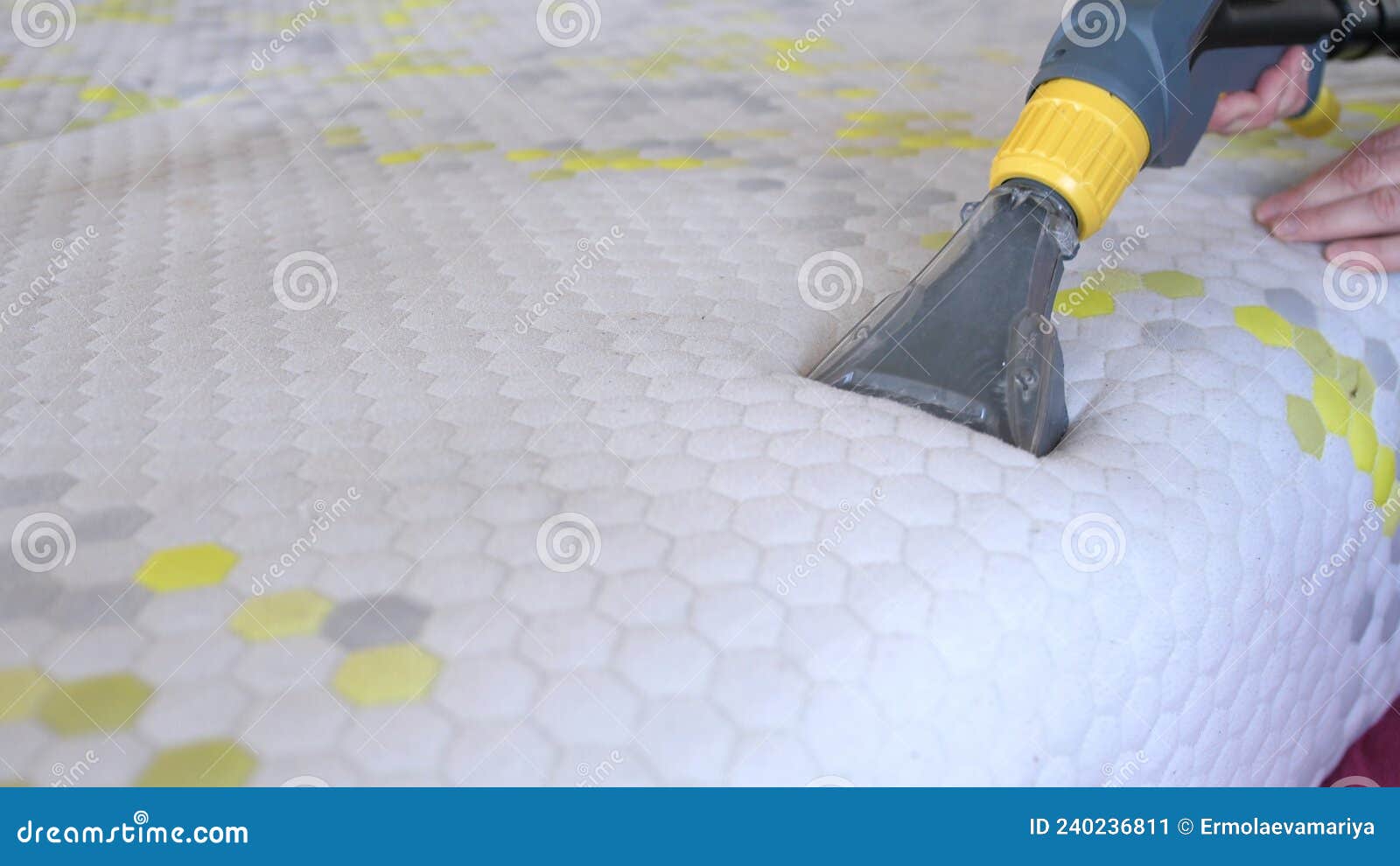 male worker cleaning a mattress with vacuum cleaner.professionally extraction method. upholstered furniture. mattress