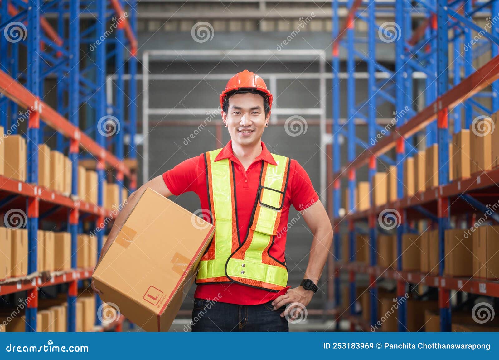 Male Worker in Hardhat Holding Cardboard Box Walking through in Retail