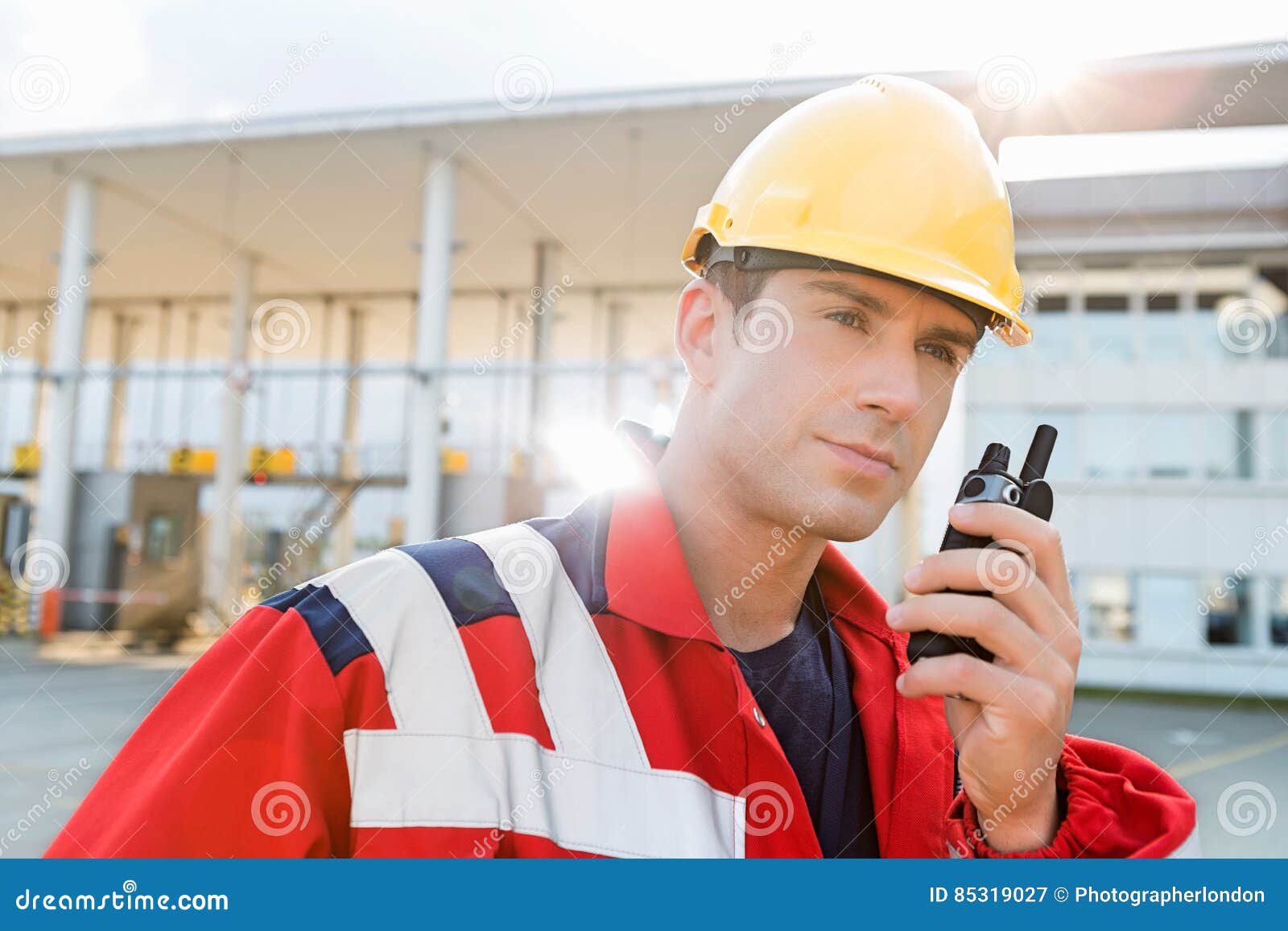 Male Worker Using Walkie-talkie in Shipping Yard Stock Image - Image of ...