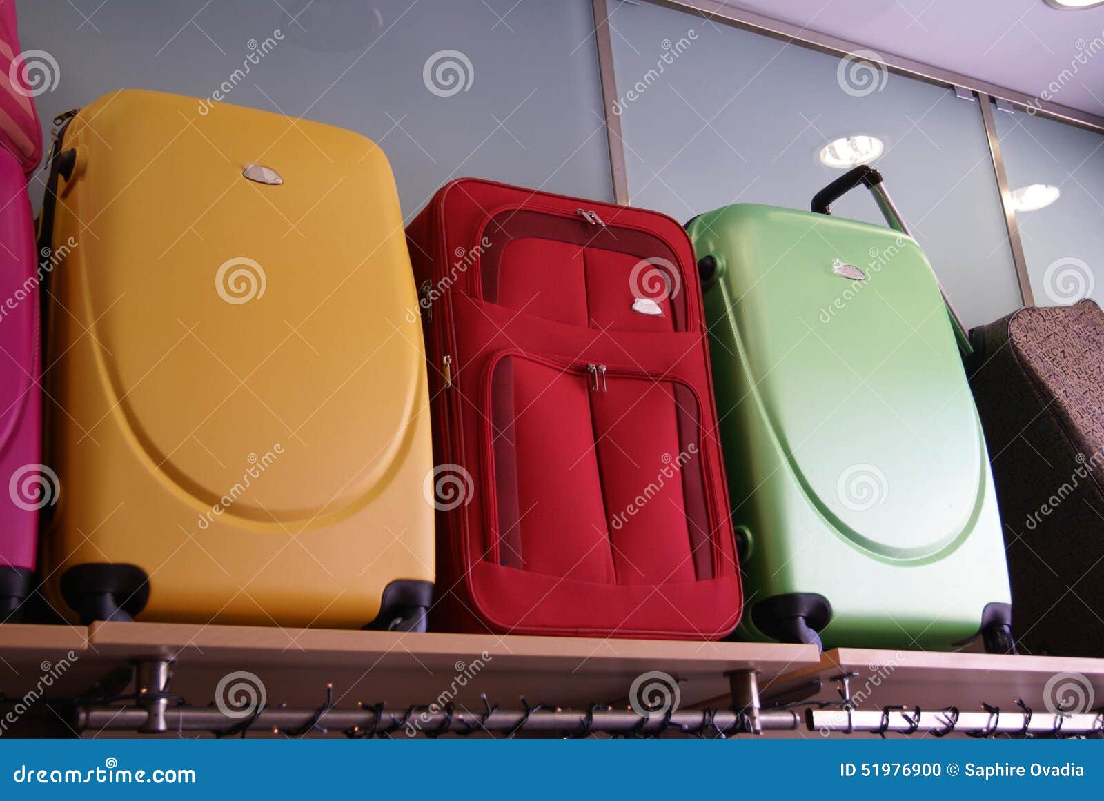 Maletas en un estante de archivo. Imagen de compras - 51976900