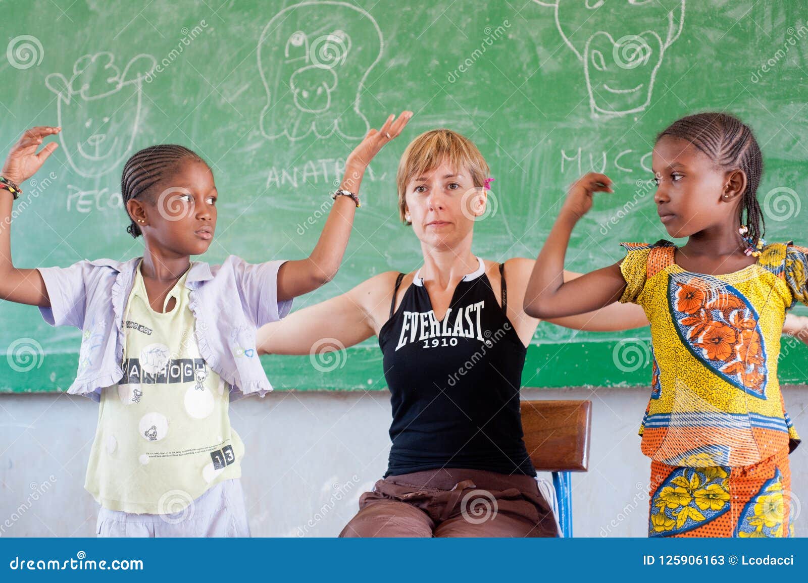 White Caucasian Woman Teaching Black Children In Africa