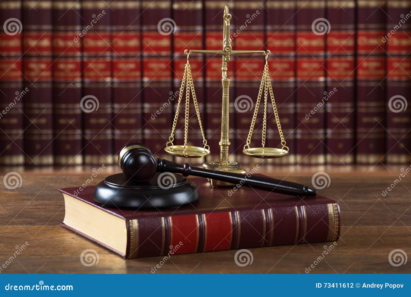 mallet and legal book with justice scale on table