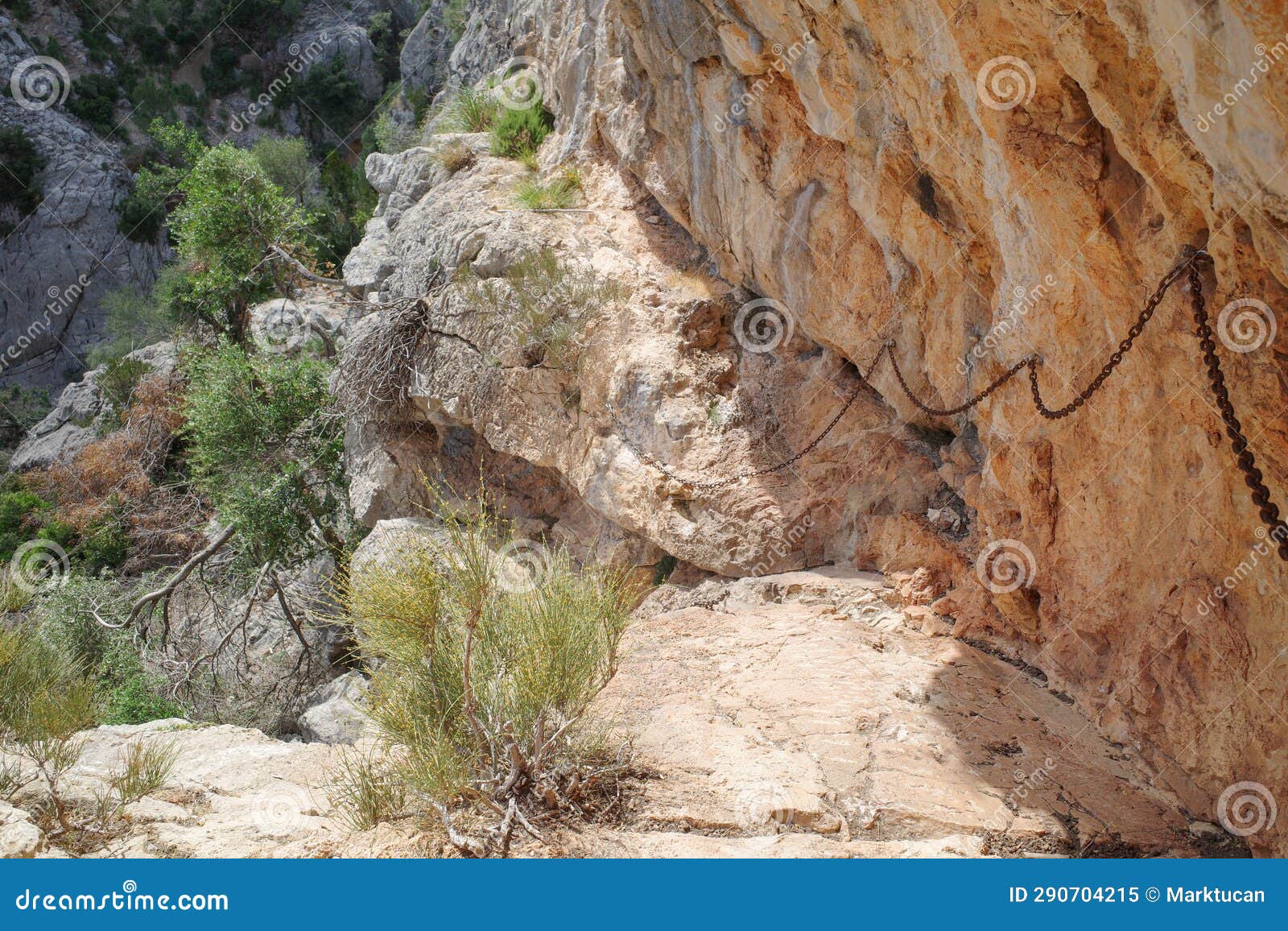 mallorca, spain - 12 june, 2023: chain railings on a steep section of the gr221 hiking trail in the tramontana mountains, mallorca