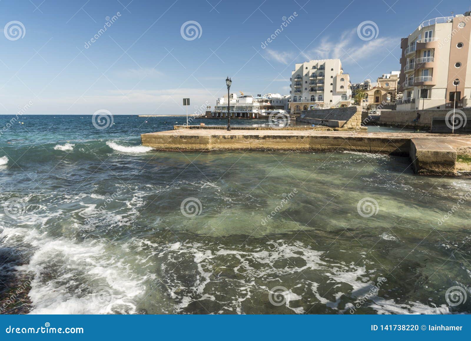 Rough Sea and Breakwater in Xemxija Bay, Bugibba, Malta. Editorial