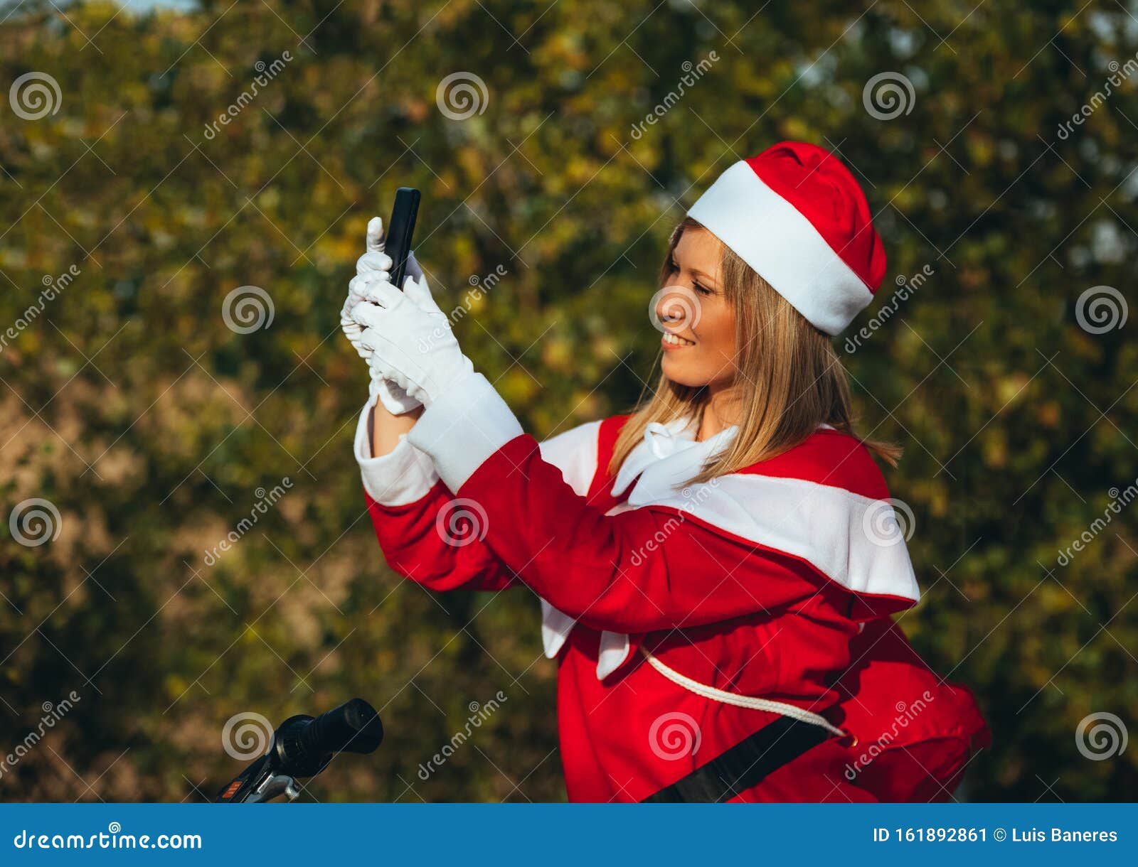 mama noel making herself a selfie on the bicycle with expression of happiness