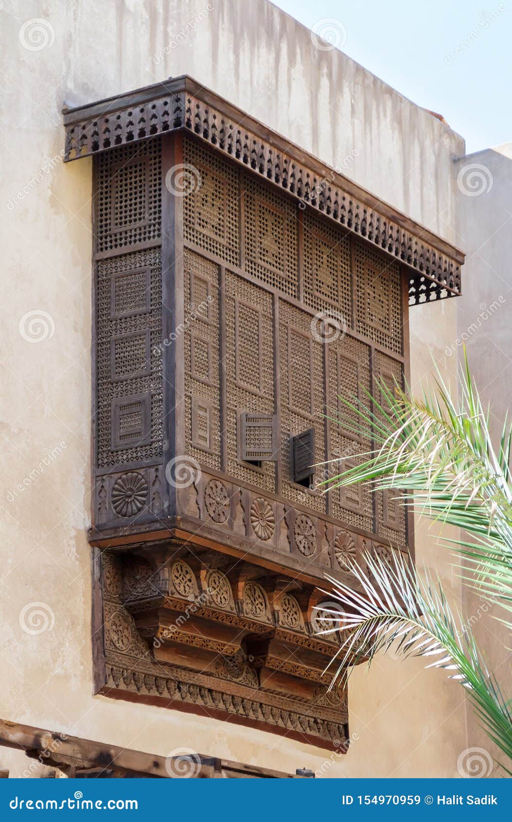 mamluk era style oriel window covered by interleaved wooden grid - mashrabiya - on stone wall, cairo, egypt