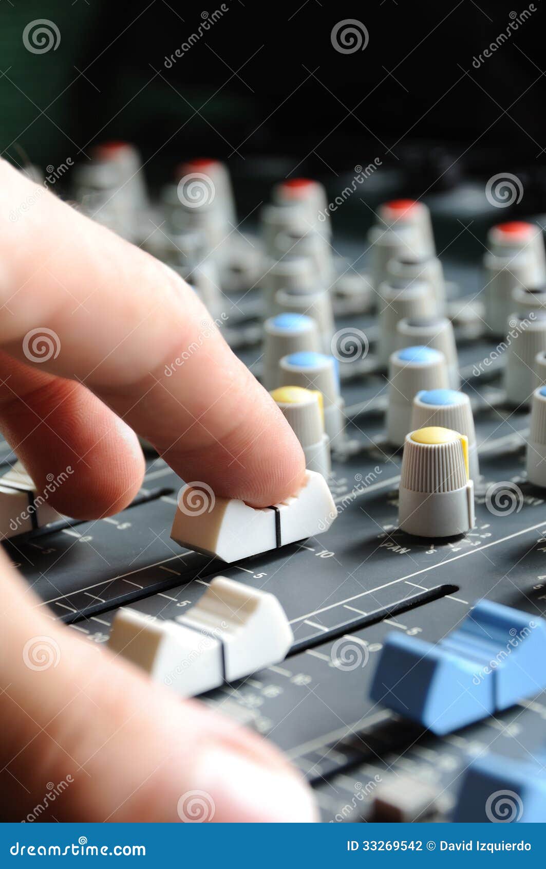 man adjusting audio mixer