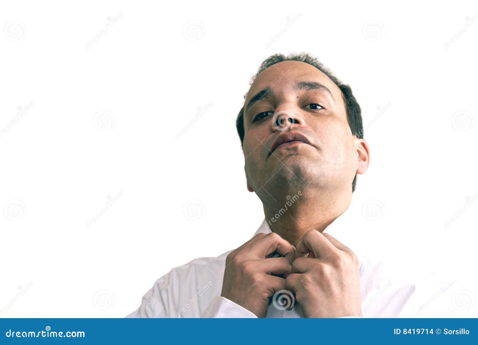 Businessman fastening collar. Black businessman fixing collar of white shirt, studio background.