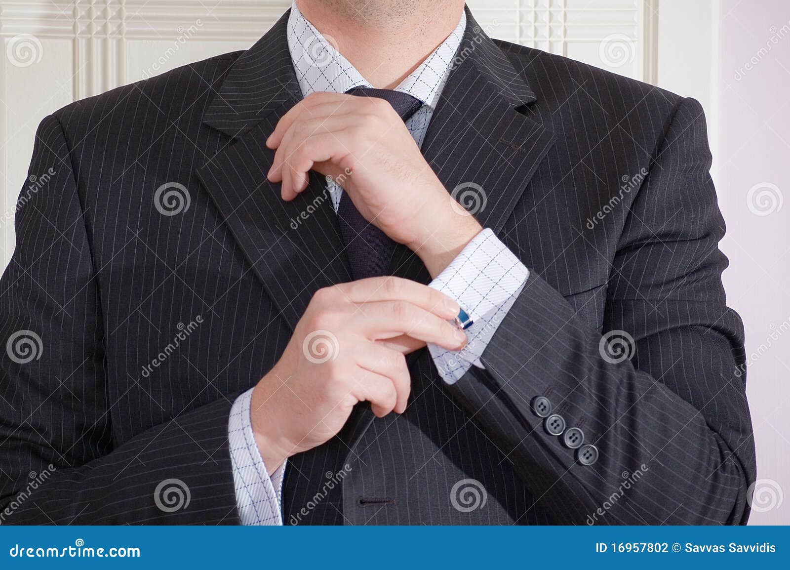 Man Adjusting Cufflink stock photo. Image of executive 16957802