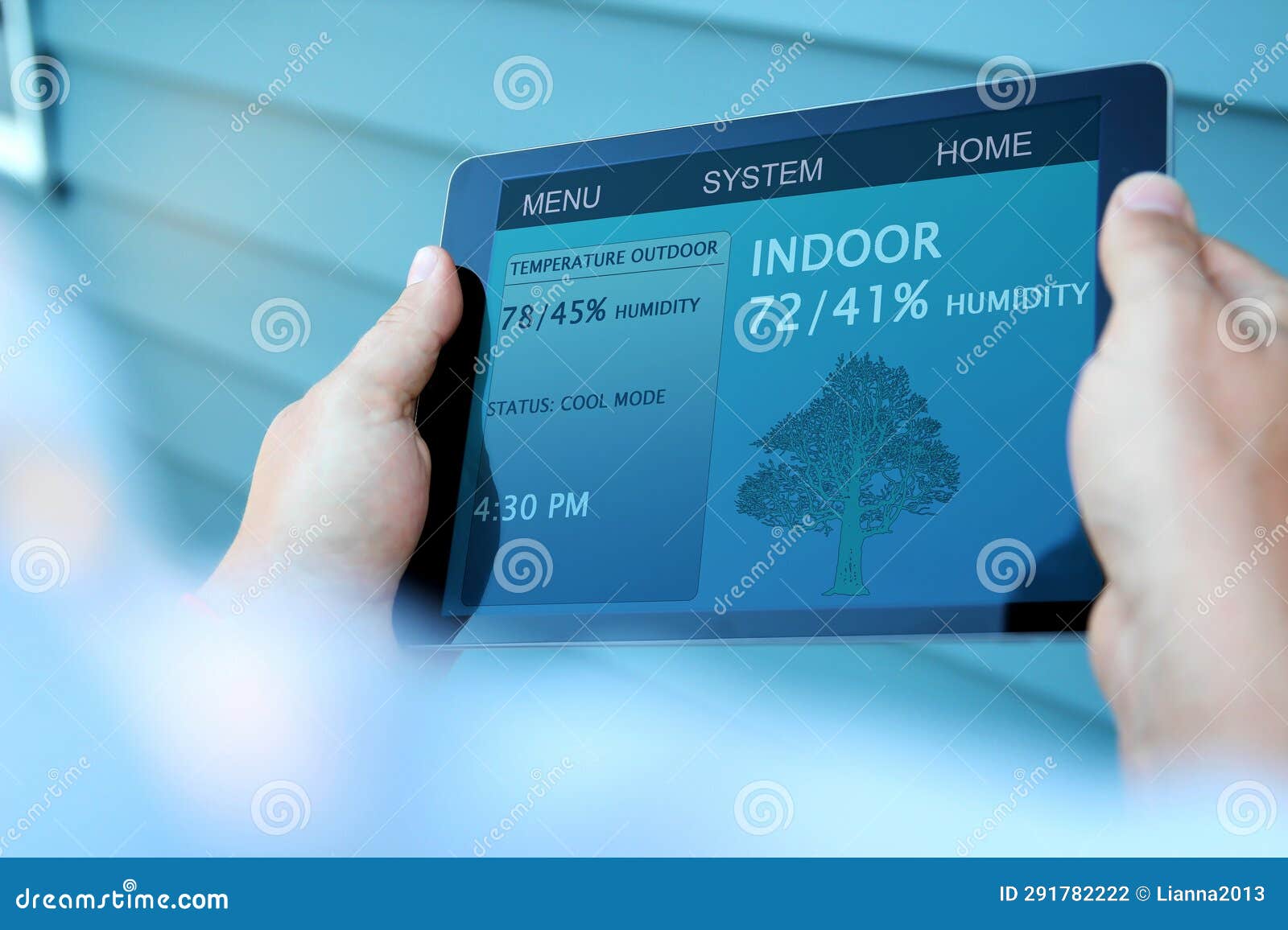 man is adjusting a temperature using a tablet with smart home app