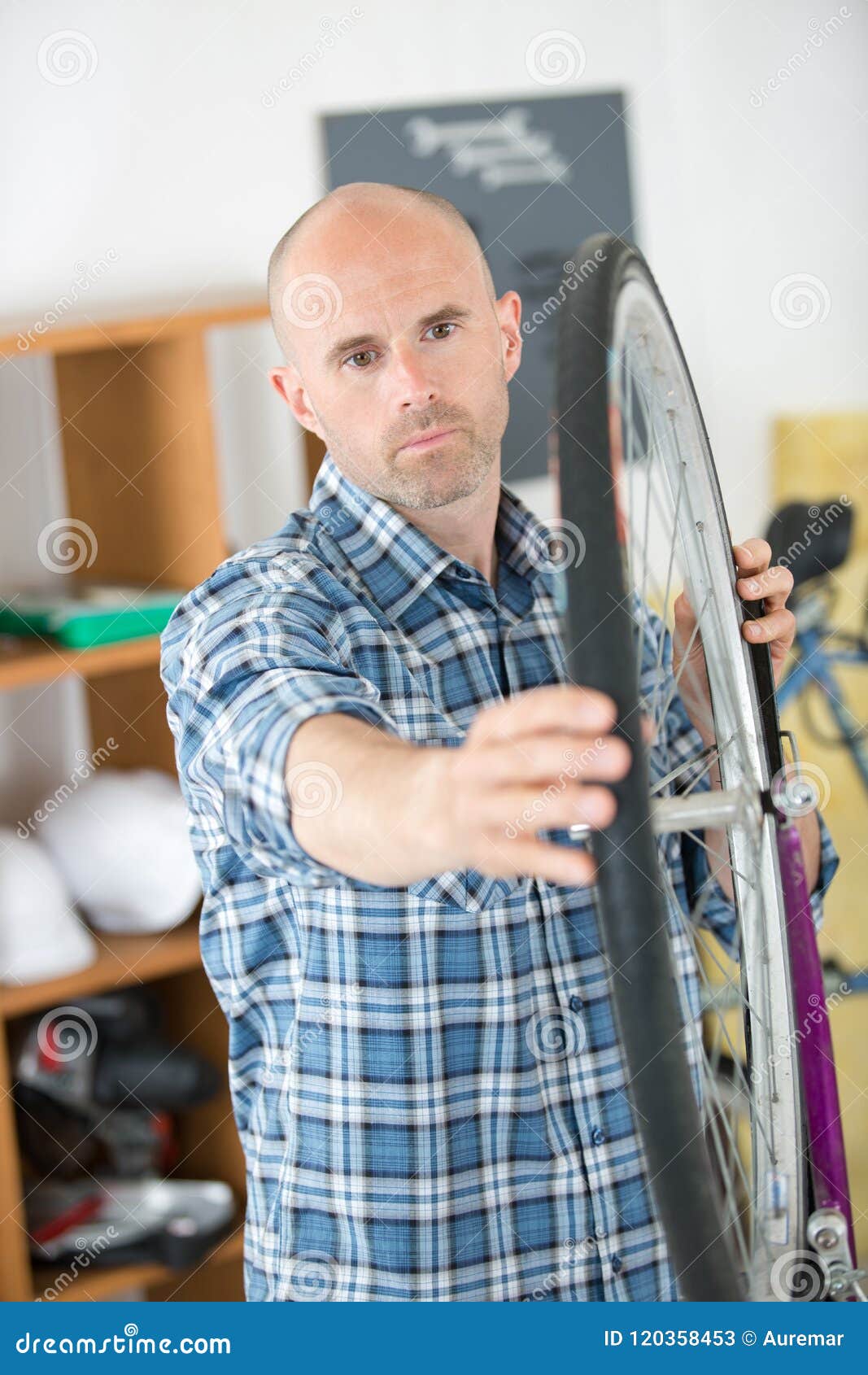 Man aligning bicycle wheel stock image. Image of spokes 120358453