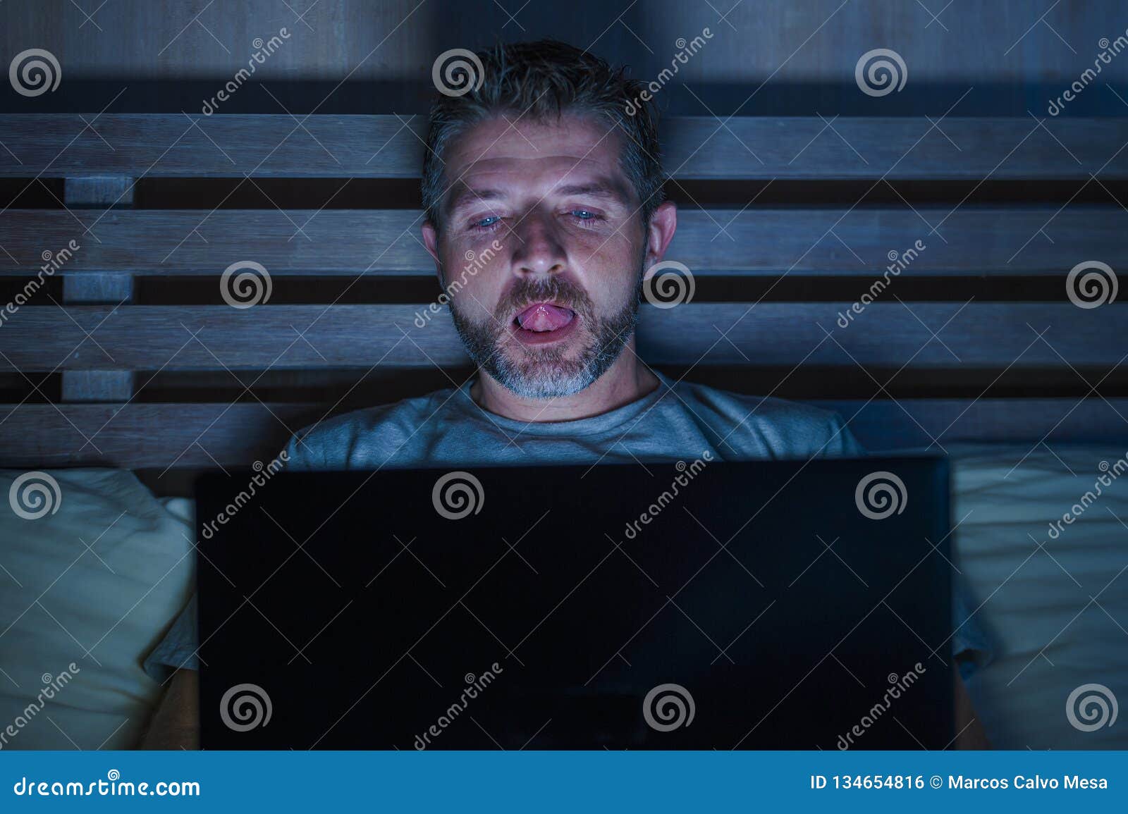 Man Alone In Bed Playing Cybersex Using Laptop Computer ...