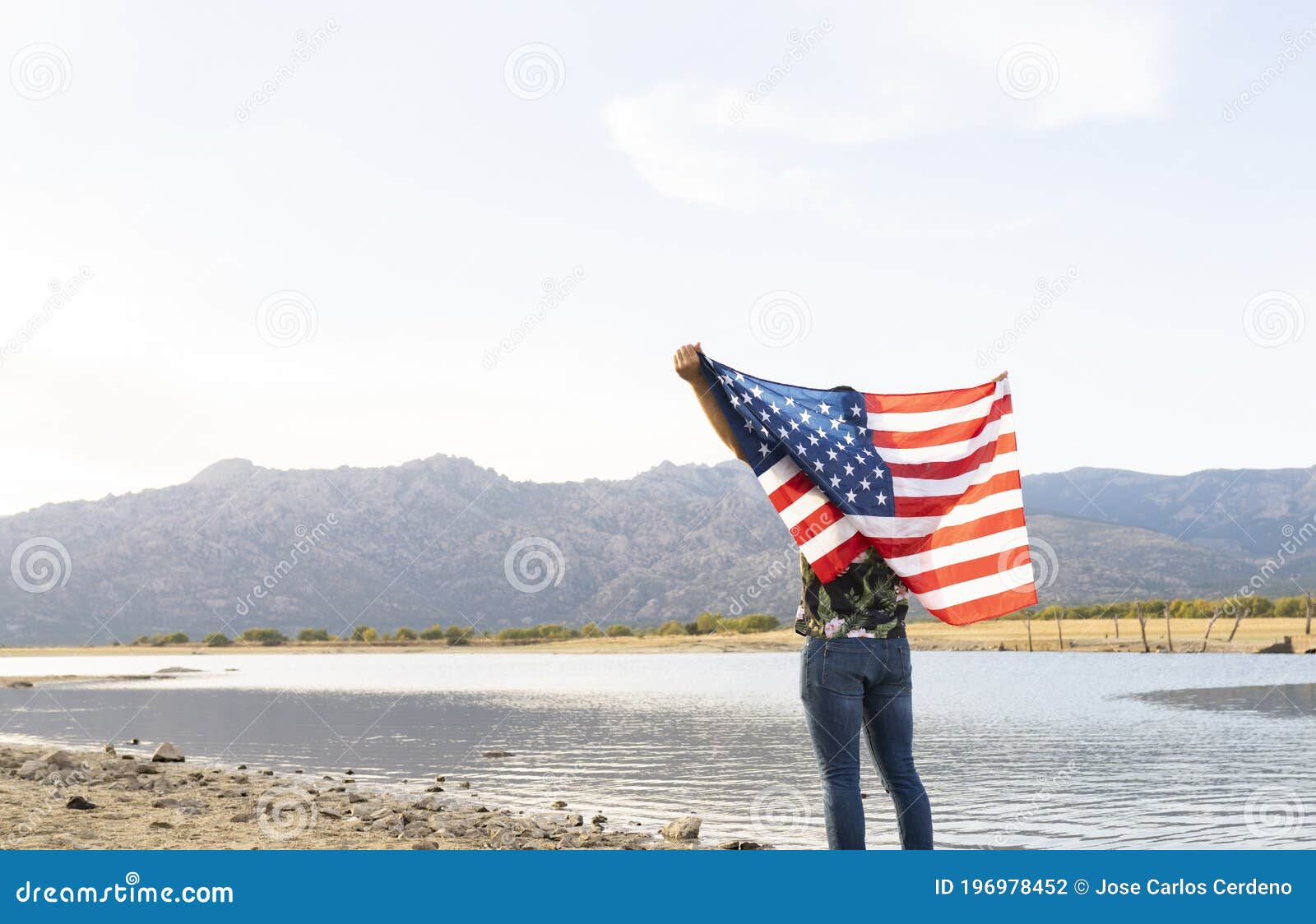 A Man with an American Flag in a Lake Stock Photo Image of happy