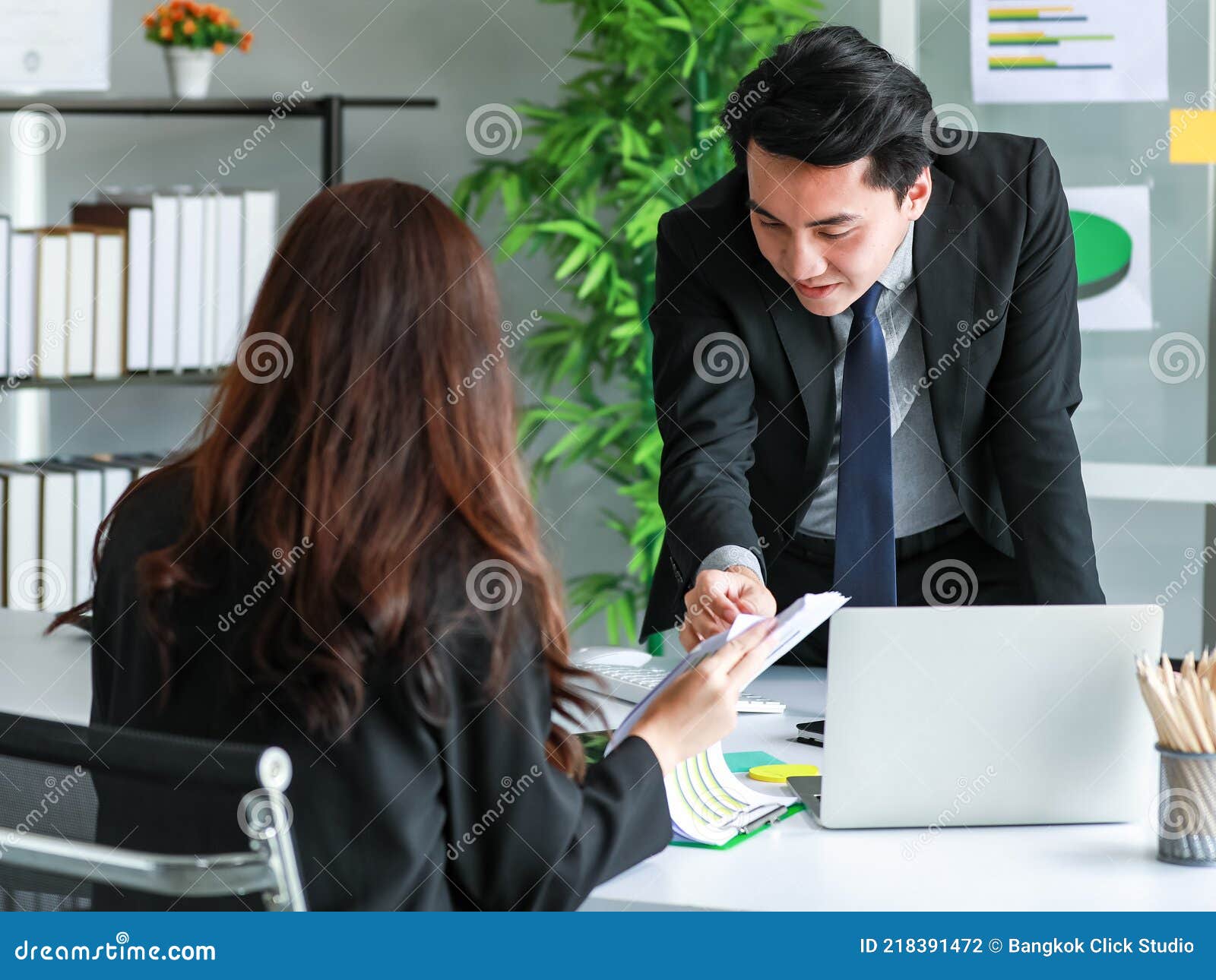 man ans woman working together in modern office. team and colleauges concept