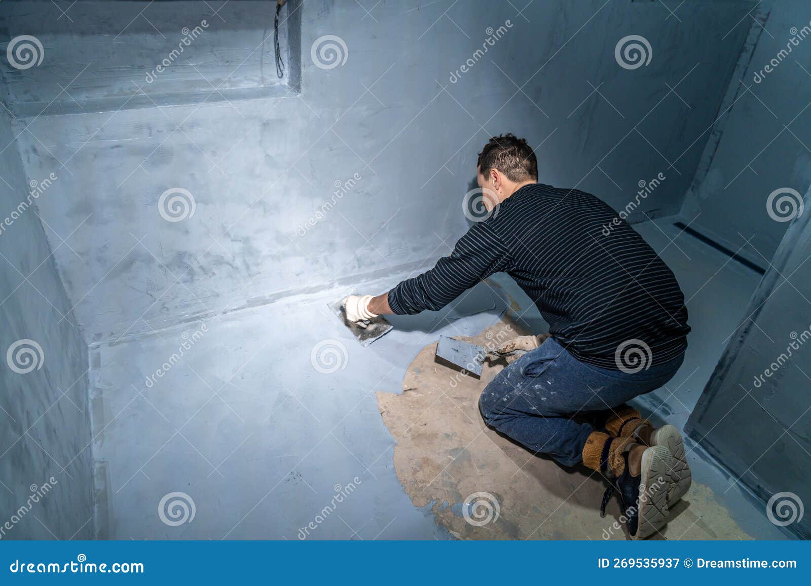 Man Applies Insulation To a Bathroom Floor Stock Image Image of