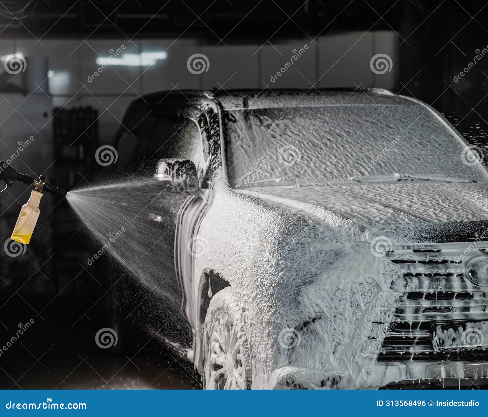 Man Applying Foam To Black Car in Car Wash. Stock Photo Image of