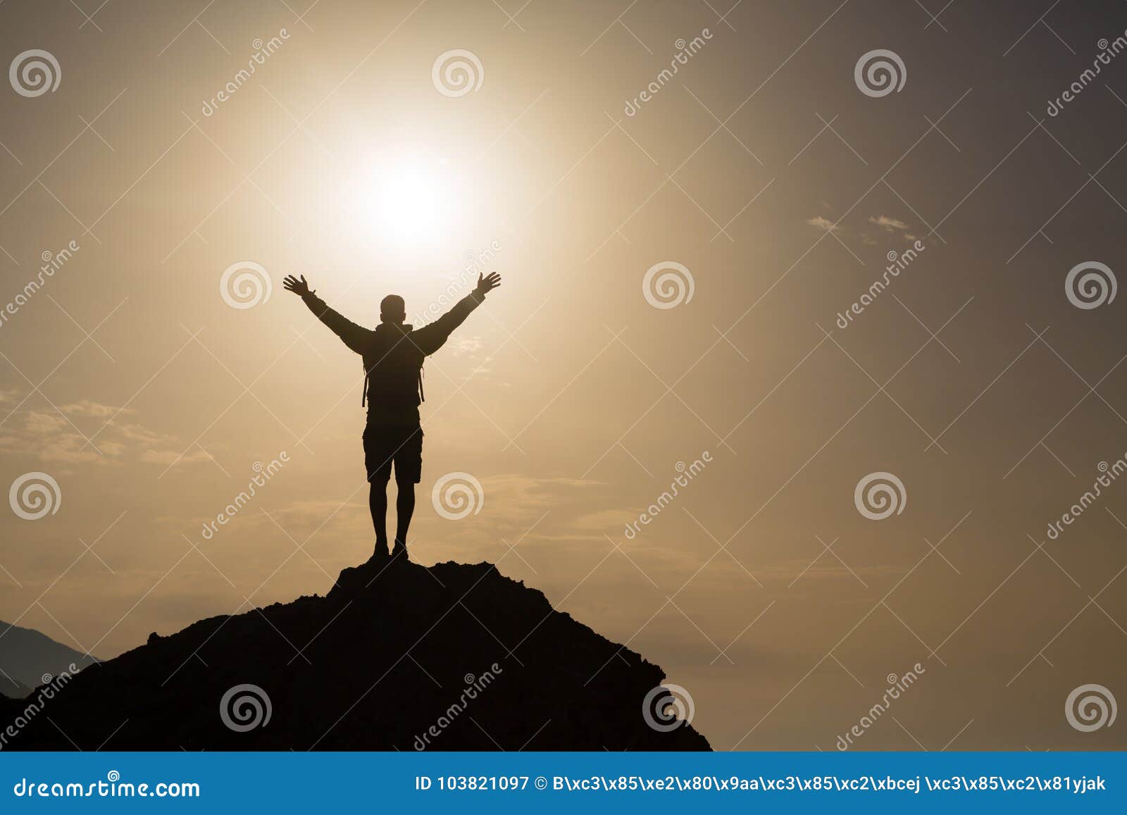 man with arms outstretched celebrate mountains sunrise