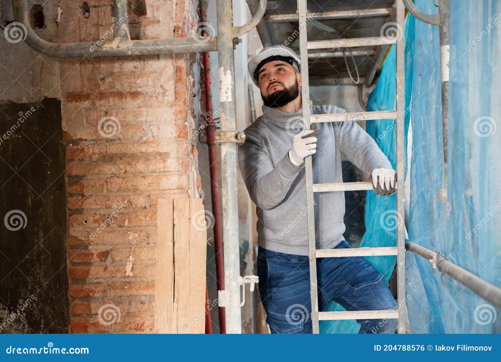 Man Ascending Up Ladder during House Reconstruction Stock Photo Image