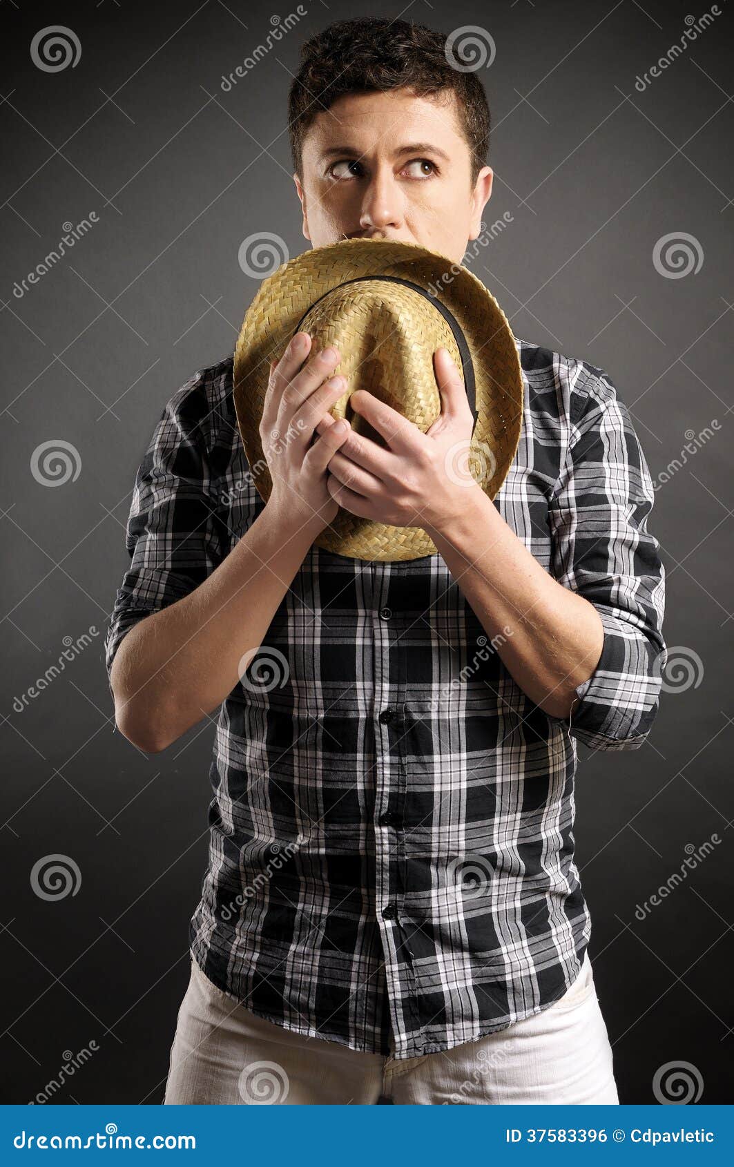 man ashamed covering with a hat