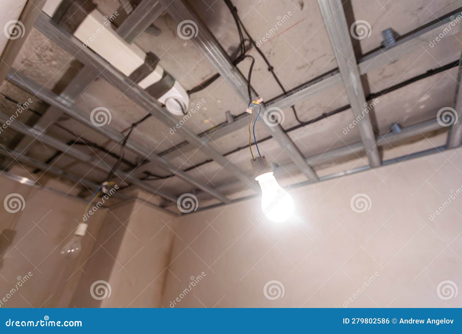Man Assembles Profile Metal Frame for Plasterboard Ceilings Stock Photo