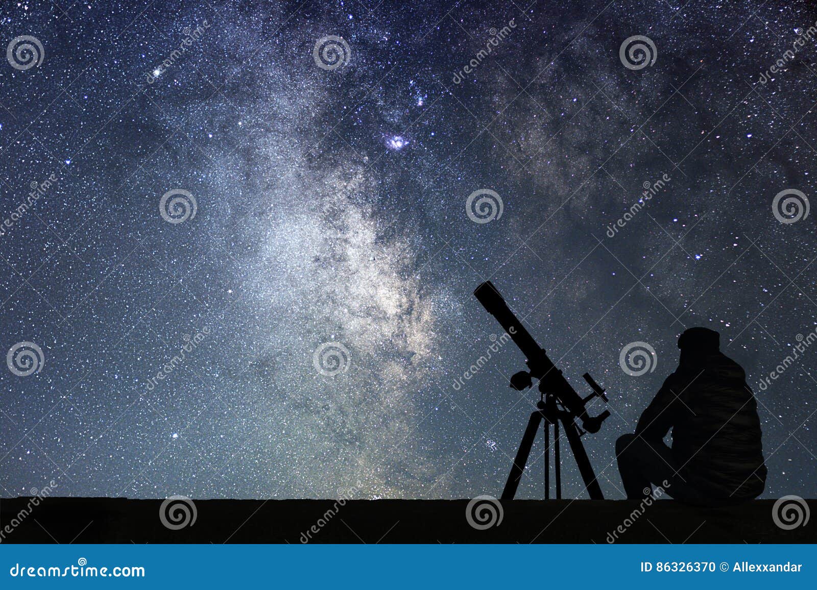 man with astronomy telescope looking at the stars.