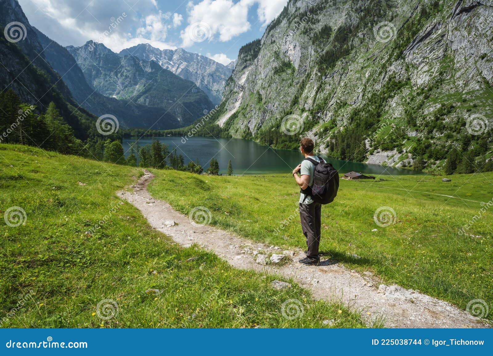 man with backpack on summer hike around hinterer gosausee, salzkammergut. austria
