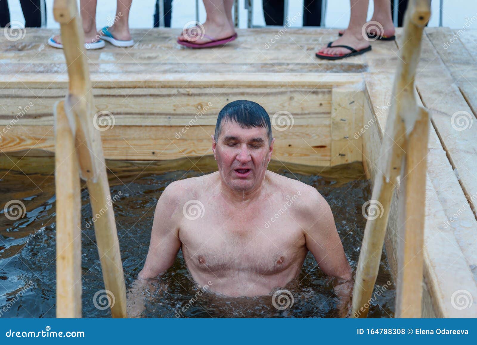 Man Bathes into Cold Water of Ice-hole on Epiphany Day. Traditional Ice ...