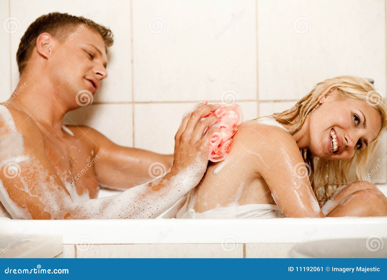 Man bathing his wife stock image