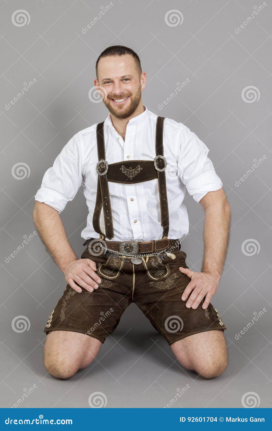 man in bavarian traditional lederhosen kneeling