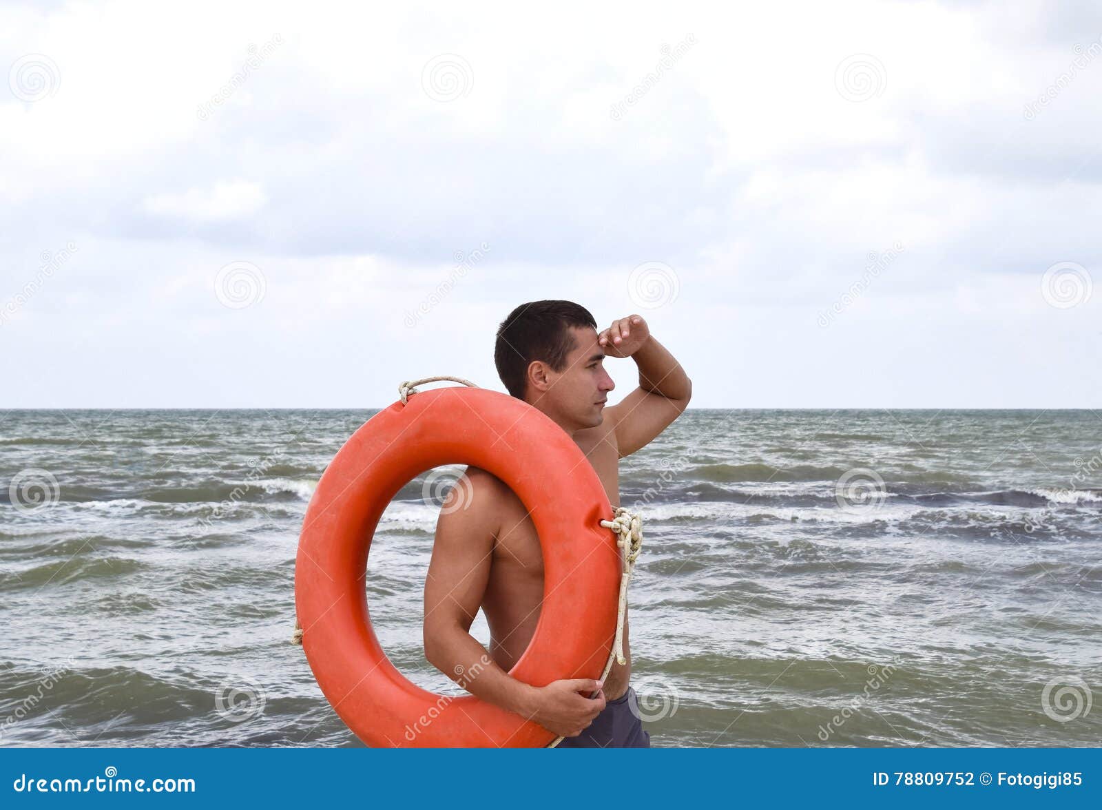 The Man on the Beach with a Lifebuoy Stock Photo - Image of bouy ...