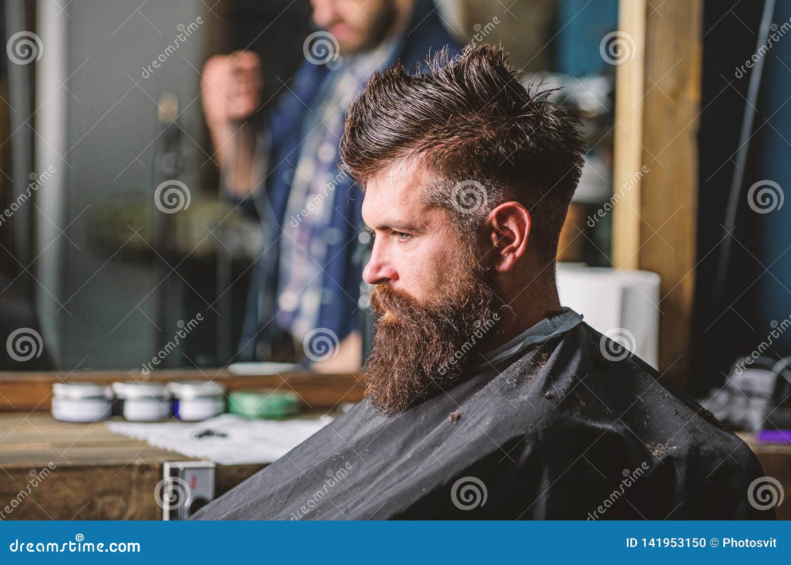 Man with Beard Covered with Black Cape Sits in Hairdressers Chair ...